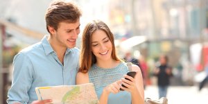 Couple Smiling and Holding Map and Phone